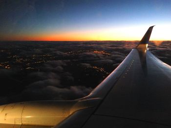 Cropped image of airplane at sunset