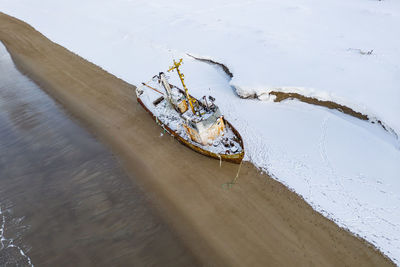 High angle view of abandoned boat on snow covered land