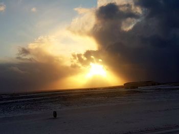 Scenic view of beach against sky during sunset