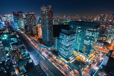 High angle view of illuminated buildings in city at night