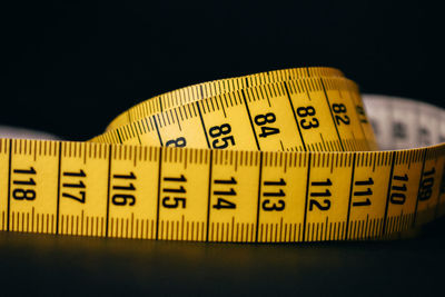 Close-up of tape measure on black background