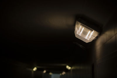 Lamp in tunnel. light in hallway. darkness in underpass. electric light.