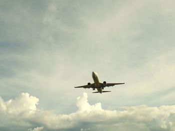 Low angle view of airplane flying in sky