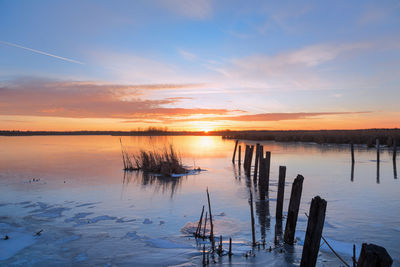 Scenic view of lake against sky during sunset