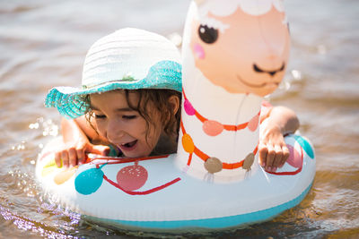 Smiling girl swimming in lake