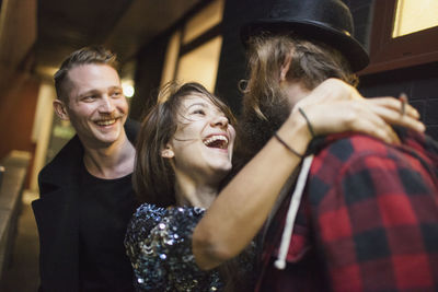 Smiling young woman embracing a friend