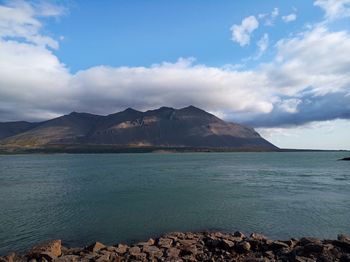 Scenic view of sea and mountains against sky