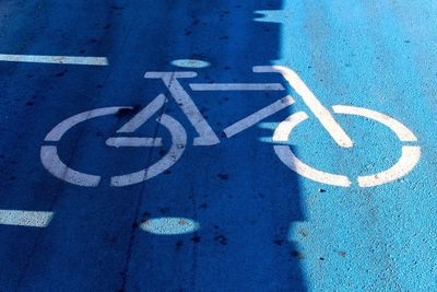 Close-up of bicycle sign on road