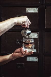 Midsection of man holding wineglass