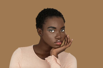 Young man looking away against yellow background