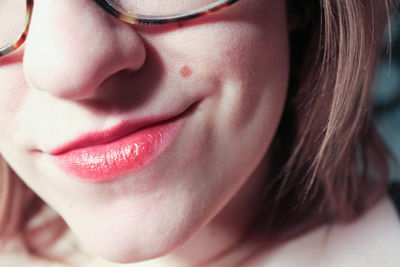 Cropped image of woman with short hair wearing pink lipstick