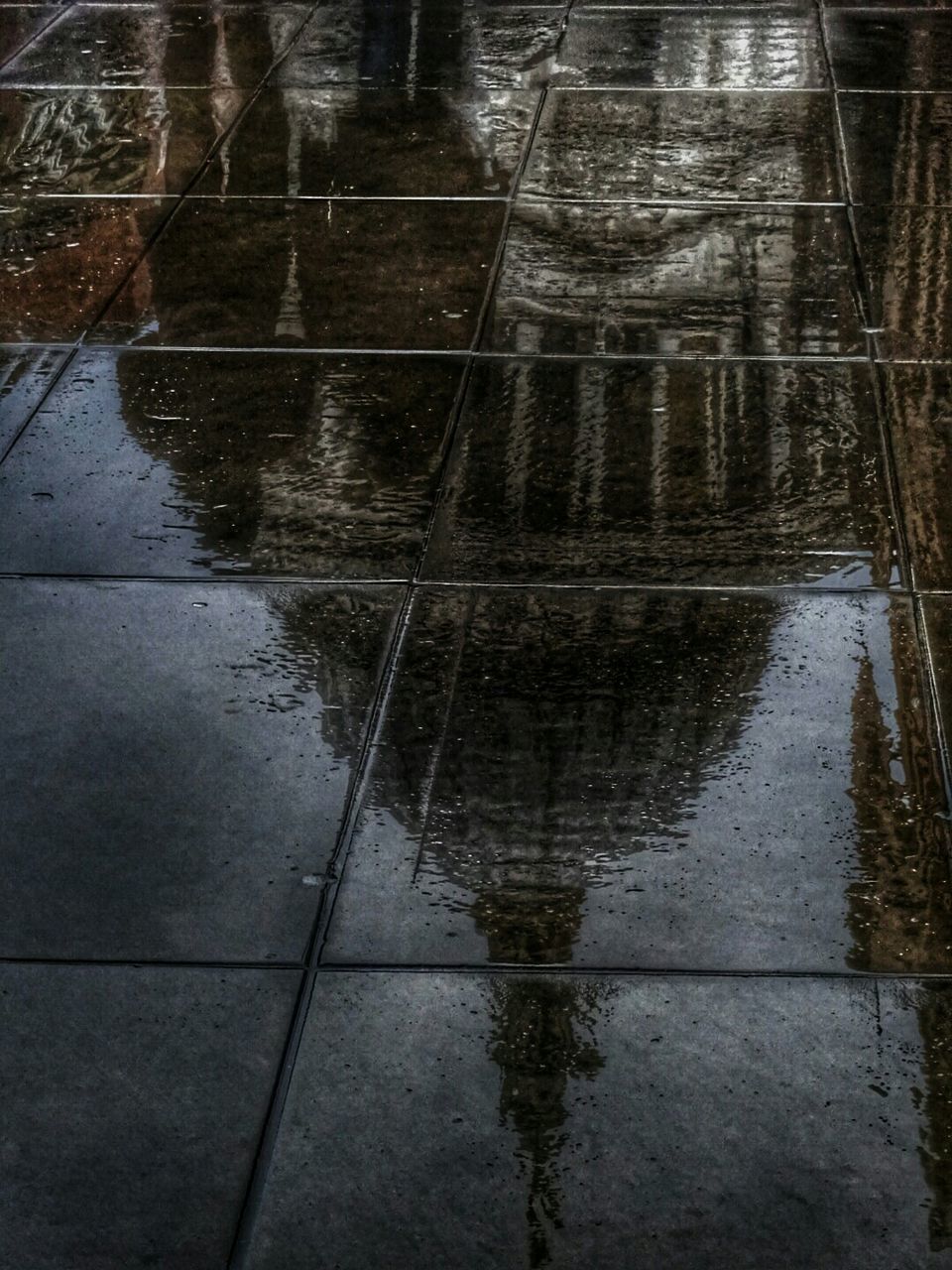 water, reflection, puddle, wet, high angle view, rain, standing water, built structure, outdoors, waterfront, day, no people, lake, architecture, street, connection, rippled, nature, weather, river