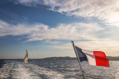 Sailboat on sea against sky