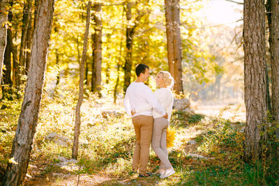 Couple standing in forest