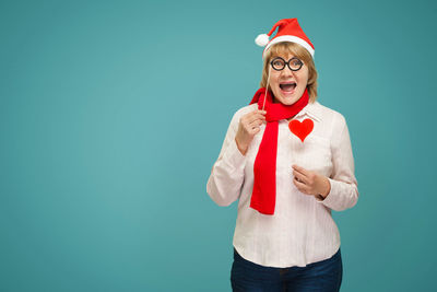 Portrait of happy man standing against red background