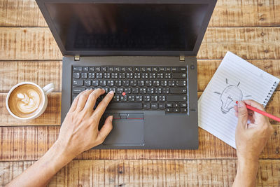 Directly above shot of person using laptop on table