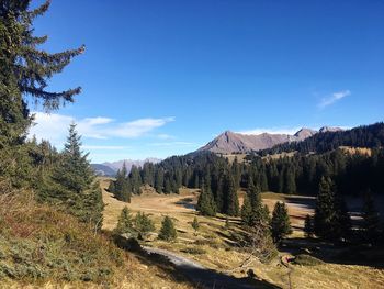 Scenic view of mountains against blue sky