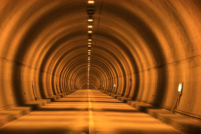 View of illuminated empty tunnel