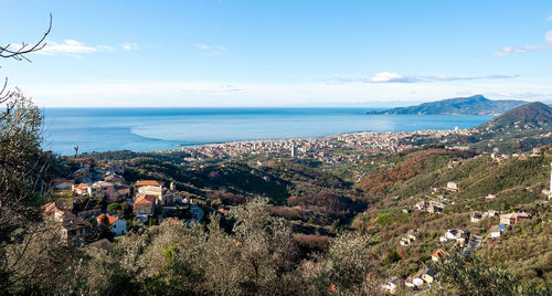 High angle view of townscape by sea against sky