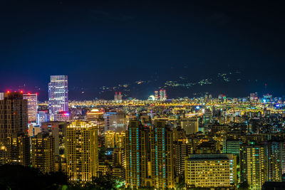 High angle view of illuminated buildings in city at night