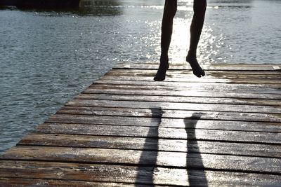 Low section of person standing on jetty