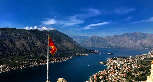 Scenic view of sea and mountains against blue sky