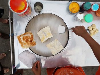 Midsection of man preparing food at market