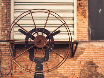 Close-up of wheel against wall