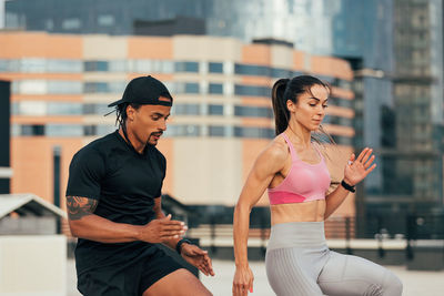 Side view of young woman exercising in gym