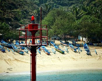 Lifeguard hut on beach against trees