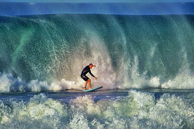 People surfing in sea