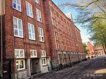 Low angle view of building by street against sky