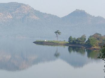 Scenic view of lake and mountains against sky