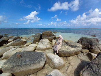 Rocks on beach against sky