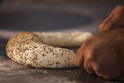 Close-up of hand holding bread on table