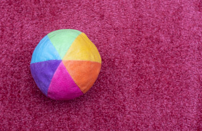 High angle view of multi colored balls on pink ball