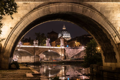 Arch bridge over river in illuminated building