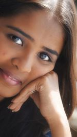 Close-up portrait of a smiling young woman