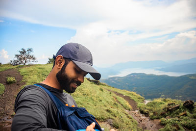 Portrait of young man against mountains