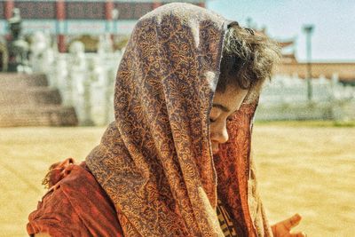 Rear view of woman in sand