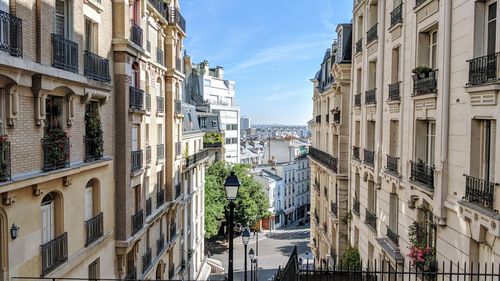 Street amidst buildings in town against sky