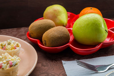 Close-up of apples in plate on table