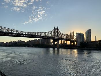 Bridge over river with city in background