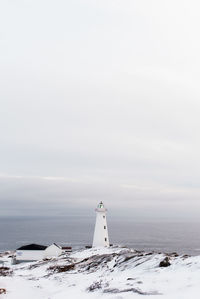 Cape spear lighthouse by sea against sky