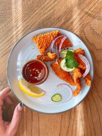 High angle view of person holding breakfast on table