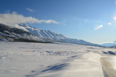 Scenic view of snowcapped mountains against sky