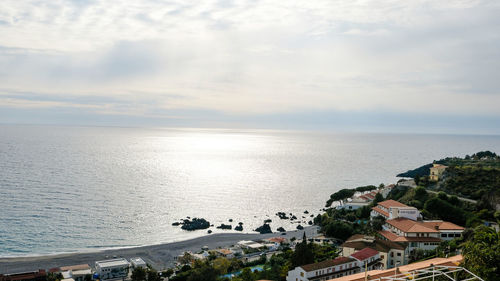 High angle view of sea and buildings against sky