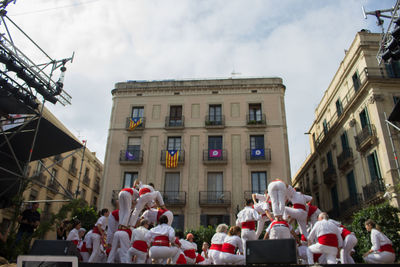 People in front of building against sky