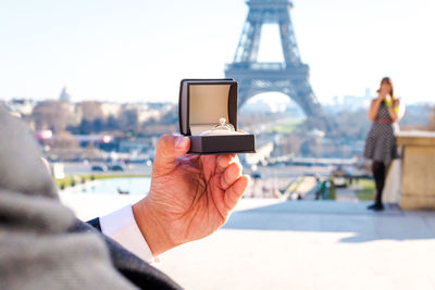 Close-up of man holding engagement ring