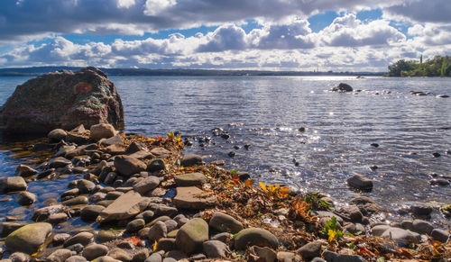 Rocks on beach against sky